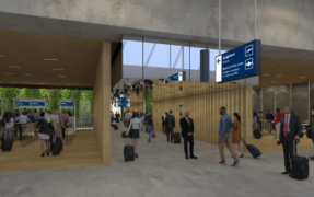 Travelers walking through an open terminal area with overhead signs, illustrating seamless movement without stopping or ticket checks