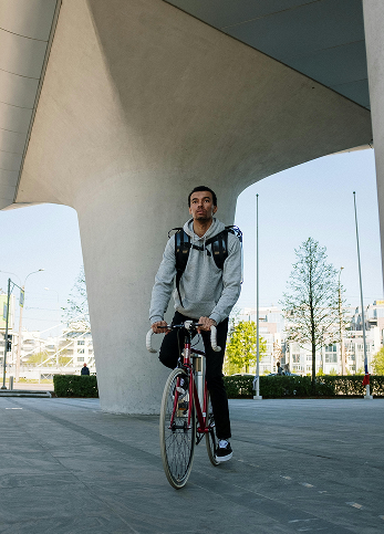 Early 20's male riding a bike