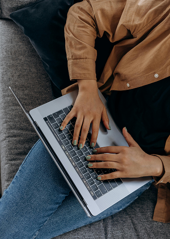 Woman typing her password on a Mac Book